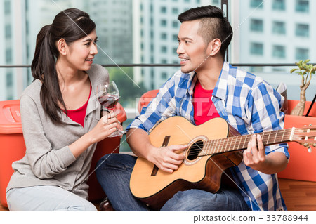 After moving together young man plays love song 33788944