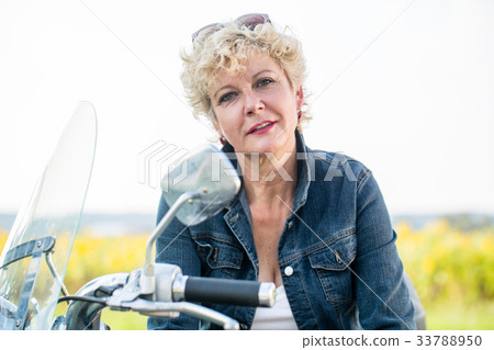 Active senior woman wearing a blue denim jacket 33788950