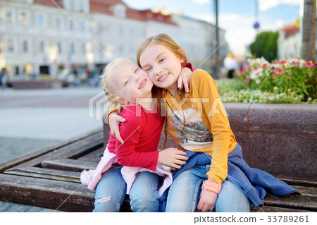 Two cute little sisters sightseeing in Vilnius, Lithuania 33789261