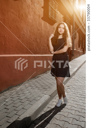 Beautiful brunette young woman wearing dress and Beautiful brunette young woman wearing dress and 33790004