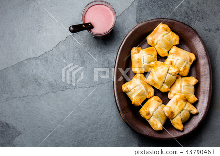 Mini chilean empanadas on clay plate with typical 33790461