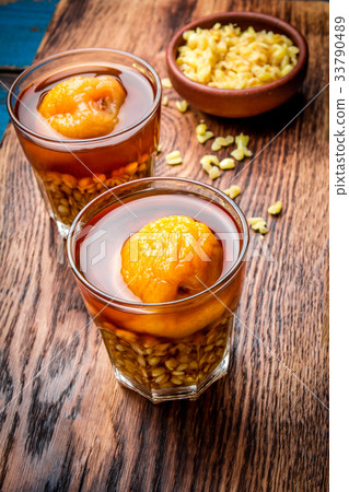 Mote con huesillo. Traditional Chilean drink made Mote con huesillo. Traditional Chilean drink made 33790489