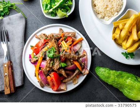Peruvian dish Lomo saltado - beef tenderloin with 33790575
