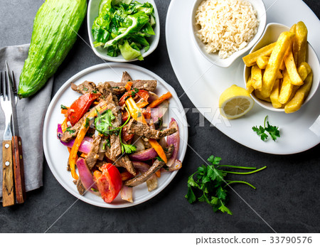 Peruvian dish Lomo saltado - beef tenderloin with 33790576