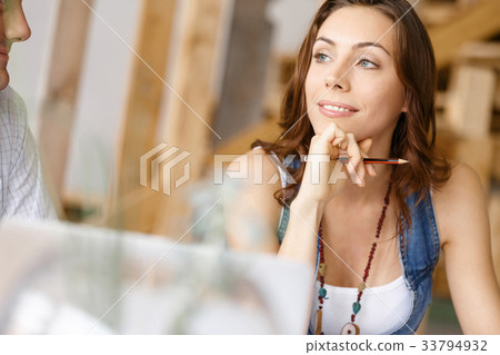 Young pretty woman sitting at her desk Young pretty woman sitting at her desk 33794932