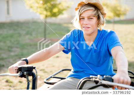 Boy riding farm truck in vineyard Boy riding farm truck in vineyard 33796192