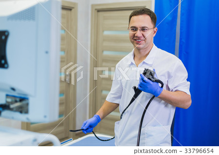 proctologist holding anoscope at hospital ward proctologist holding anoscope at hospital ward 33796654