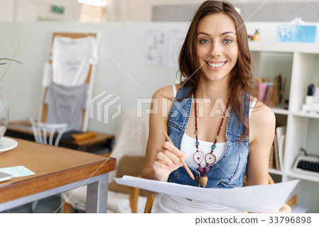 Young woman standing in creative office 33796898