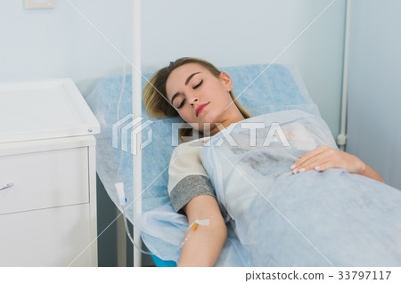 Woman Lying Down In Hospital Bed and smiling. 33797117