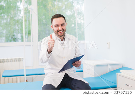 Cheerful young doctor holding a clipboard and Cheerful young doctor holding a clipboard and 33797130