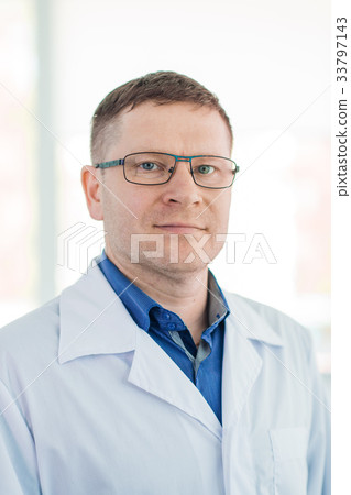 Portrait of confident mature male surgeon standing Portrait of confident mature male surgeon standing 33797143