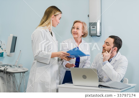 Portrait of a smart young doctors works in a Portrait of a smart young doctors works in a 33797174