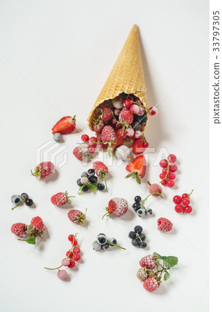 frozen berries in the ice cream cone 33797305