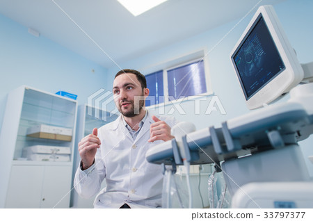 Male doctor with ultrasonic equipment during Male doctor with ultrasonic equipment during 33797377
