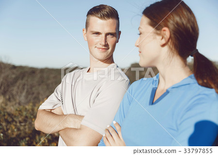 Young couple on beach in sportwear Young couple on beach in sportwear 33797855