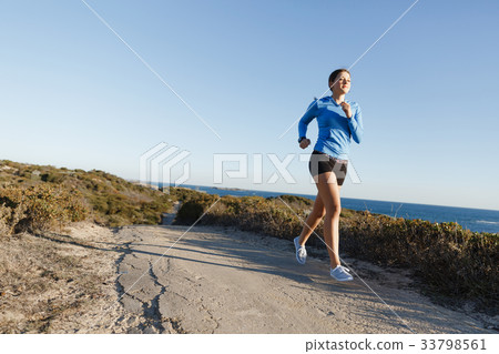 Sport runner jogging on beach working out 33798561