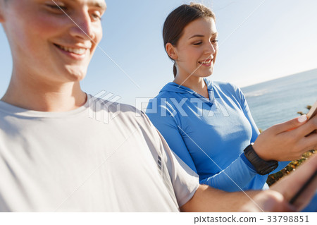 Young couple with smartphones outdoors 33798851