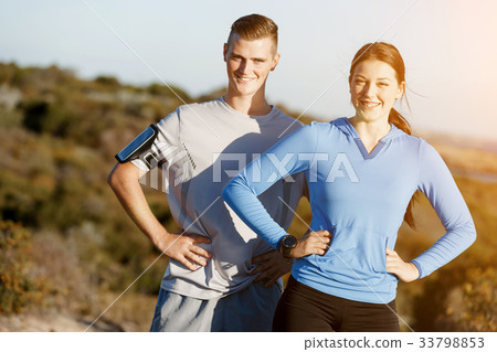 Young couple on beach training together Young couple on beach training together 33798853