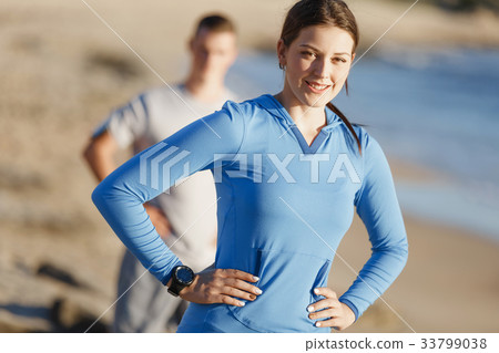 Young couple on beach training together 33799038