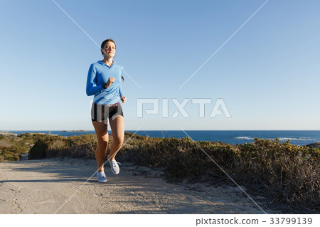 Sport runner jogging on beach working out Sport runner jogging on beach working out 33799139