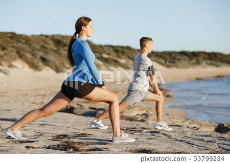 Young couple on beach training together 33799284