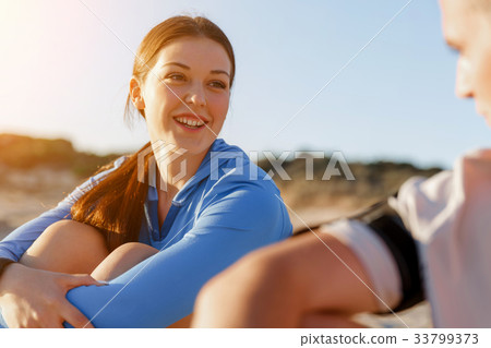 Couple in sport wear on beach 33799373