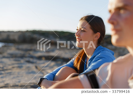 Couple in sport wear on beach Couple in sport wear on beach 33799416