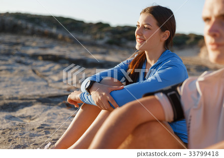 Couple in sport wear on beach Couple in sport wear on beach 33799418