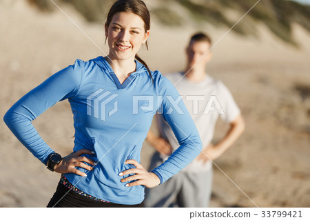 Young couple on beach training together Young couple on beach training together 33799421