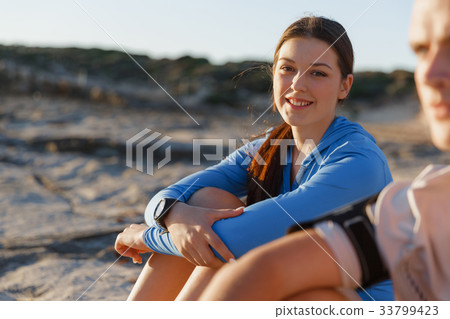Couple in sport wear on beach 33799423