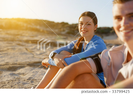 Couple in sport wear on beach Couple in sport wear on beach 33799425