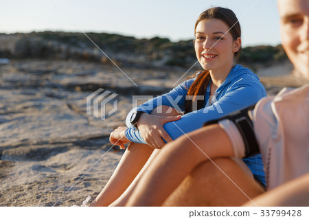 Couple in sport wear on beach Couple in sport wear on beach 33799428