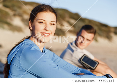 Couple in sport wear on beach Couple in sport wear on beach 33799431