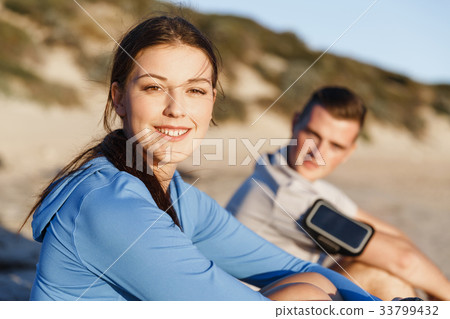 Couple in sport wear on beach Couple in sport wear on beach 33799432