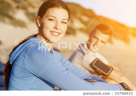 Couple in sport wear on beach Couple in sport wear on beach 33799433