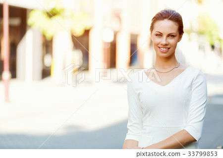Portrait of business woman smiling outdoor 33799853