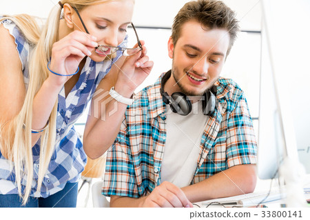 Two office workers at the desk 33800141