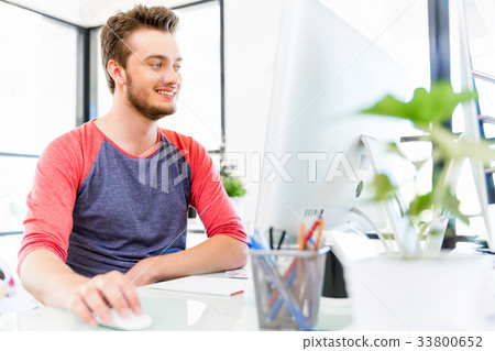 Young man working in office Young man working in office 33800652