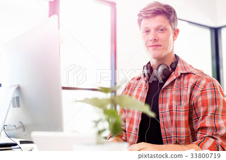 Young man working in office Young man working in office 33800719