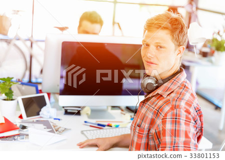 Young man working in office Young man working in office 33801153