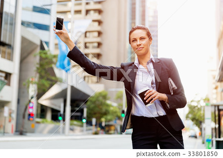 Portrait of business woman catching taxi 33801850