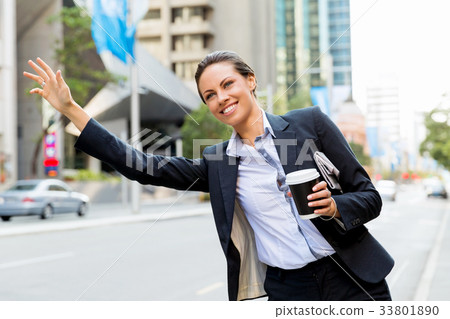 Portrait of business woman catching taxi Portrait of business woman catching taxi 33801890