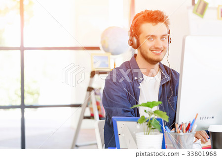 Young man working in office Young man working in office 33801968