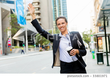 Portrait of business woman catching taxi 33801971
