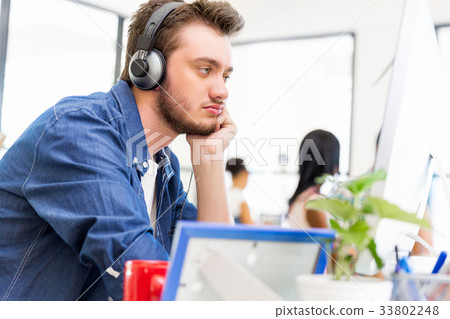 Young man working in office 33802248