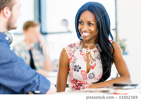 Portrait of smiling afro-american office worker sitting in offfice Portrait of smiling afro-american office worker sitting in offfice 33802369