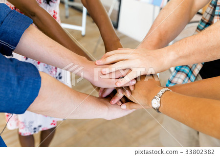 Top view of young people putting hands together 33802382