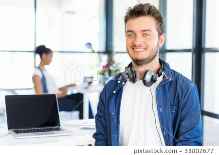Young man working in office Young man working in office 33802677