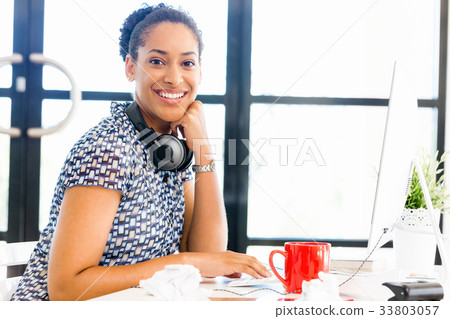 Portrait of smiling afro-american office worker sitting in offfice Portrait of smiling afro-american office worker sitting in offfice 33803057