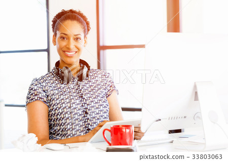 Portrait of smiling afro-american office worker in offfice Portrait of smiling afro-american office worker in offfice 33803063